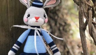 Knitted woolen grey rabbit doll